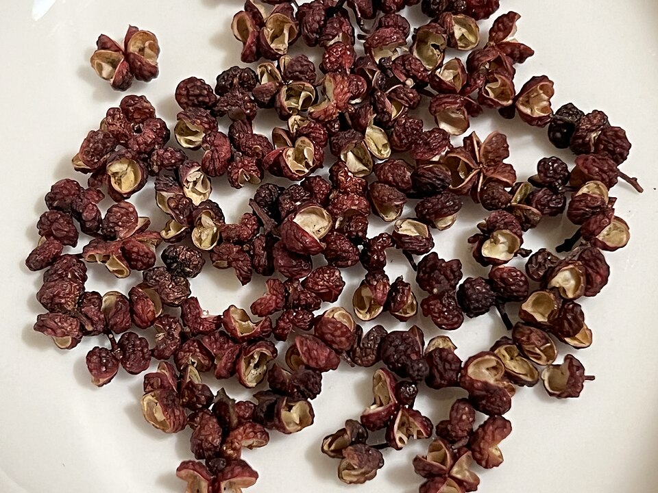 A pile of dried reddish-brown Sichuan peppercorns